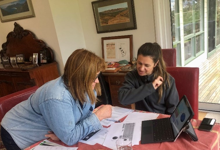 Jenny O’Sullivan and Agriculture Victoria’s farm emissions specialist, Alison Kelly, discussing emissions around a kitchen table.