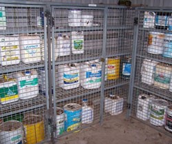 Chemical containers and drums locked in steel mesh door cabinets