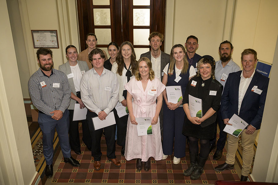 Award recipients hold up their certificates.