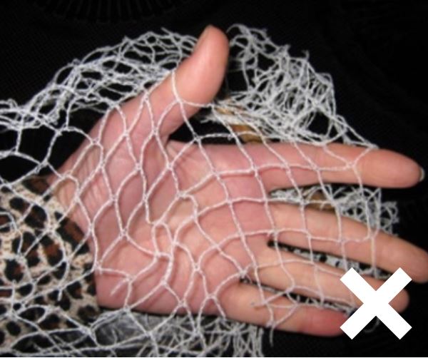 Hand holding non compliant netting, fingers are poking through the holes