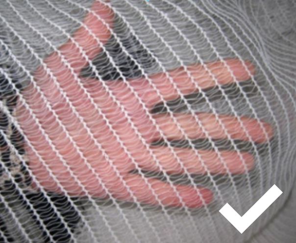 Netting over hand, netting has a fine mesh size so animals can't get stuck in it