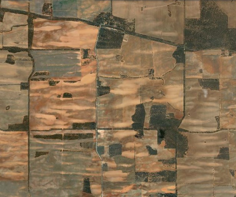 Erosion-prone sandhills - northwest Mallee Image: Bing maps. Aerial image of Meringur sandhills showing lighter eroding areas, dark timber, grey stubble and red bare soil.
