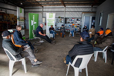 Orchardists pictured discussing farm safety at a Making Our Farms Safer workshop