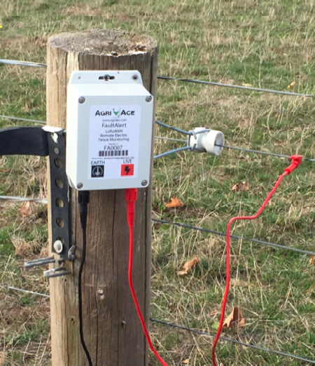 Box attached to wooden post of electric fence to monitor electric fence voltage