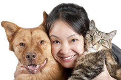 Pet owner holding dog and cat