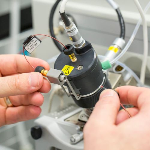 Hands calibrating metabolomics laboratory equipment