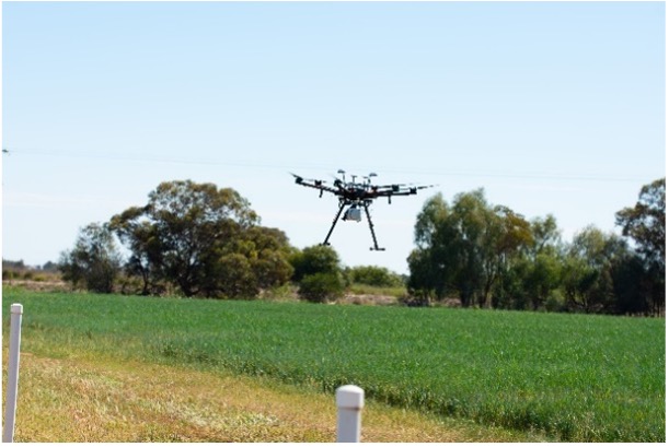 A smaller image of a drone in a field