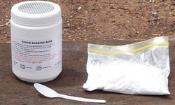 Sugar shake jar, pure icing sugar and measuring spoon