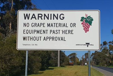 Phylloxera Control area road sign. Sign says - Warning - no grape material or equipment past here without approval - Telephone 136 186 - Agriculture Victoria