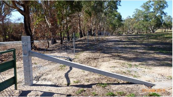 A fence shown with a concrete beam
