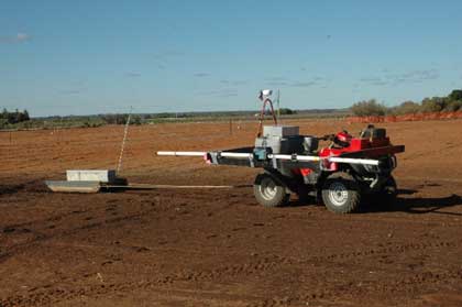 Profile view of an all-terrain vehicle dragging a sled which hold an electromagnetic sensor contained in a box