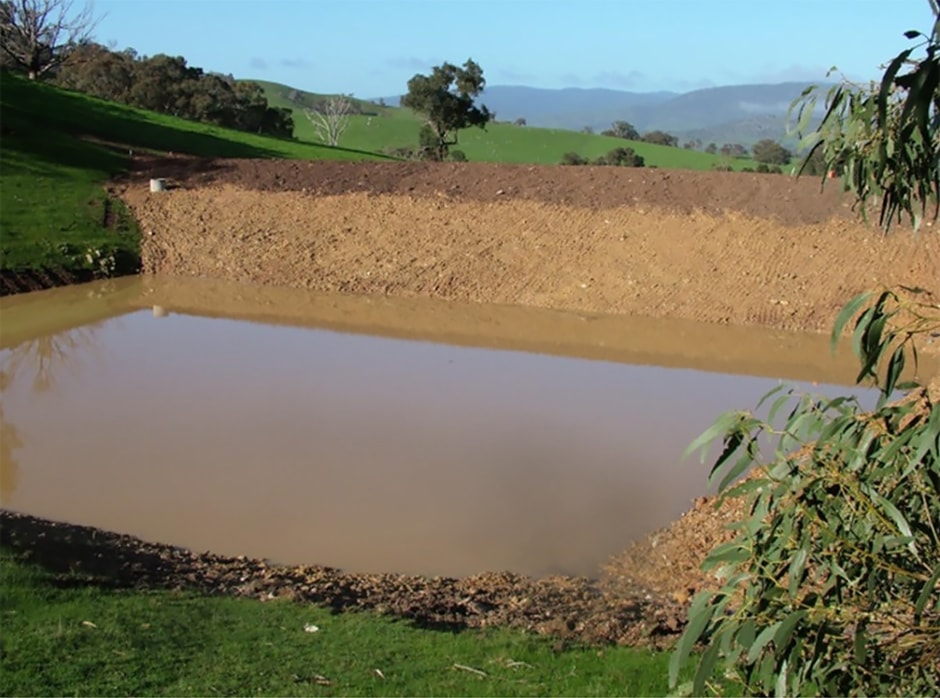 Square dam cut into hill side