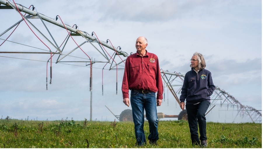Sandra and Wilco at Wilandra Farms walking next to one of their centre pivot irrigators