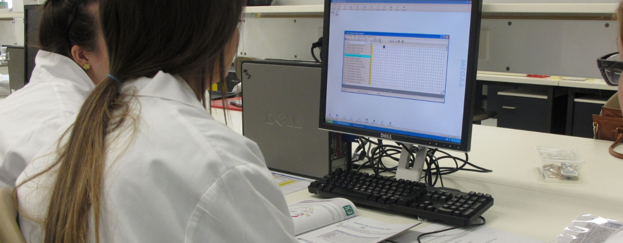 Image shows two students working at a laboratory computer