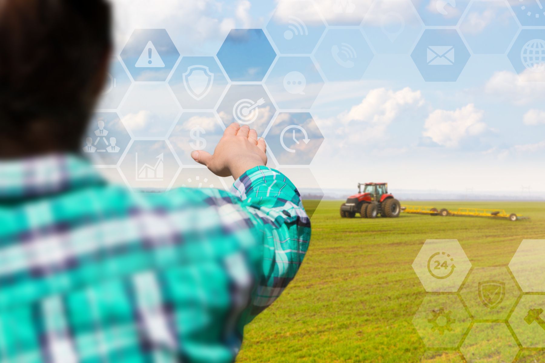 Farmer using virtual screen with tractor in background