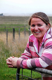 Photo of young farmer leaning on a fence