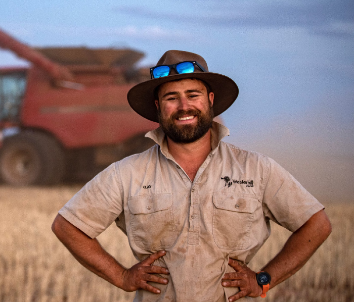 Clay Gowers, headshot outside grass and trees in background
